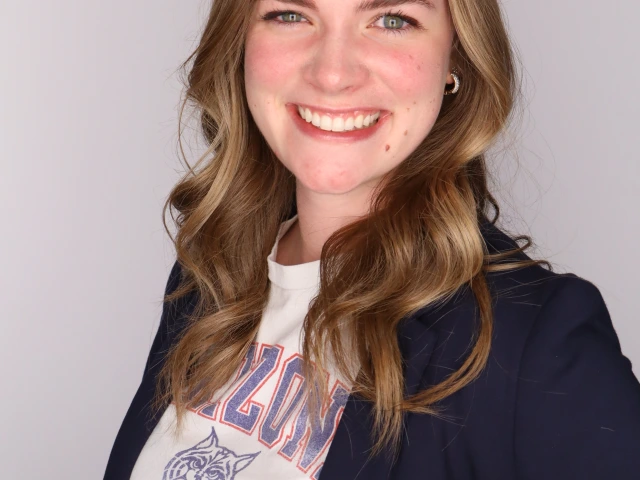 brenna in a navy balzer with a white ua teeshirt