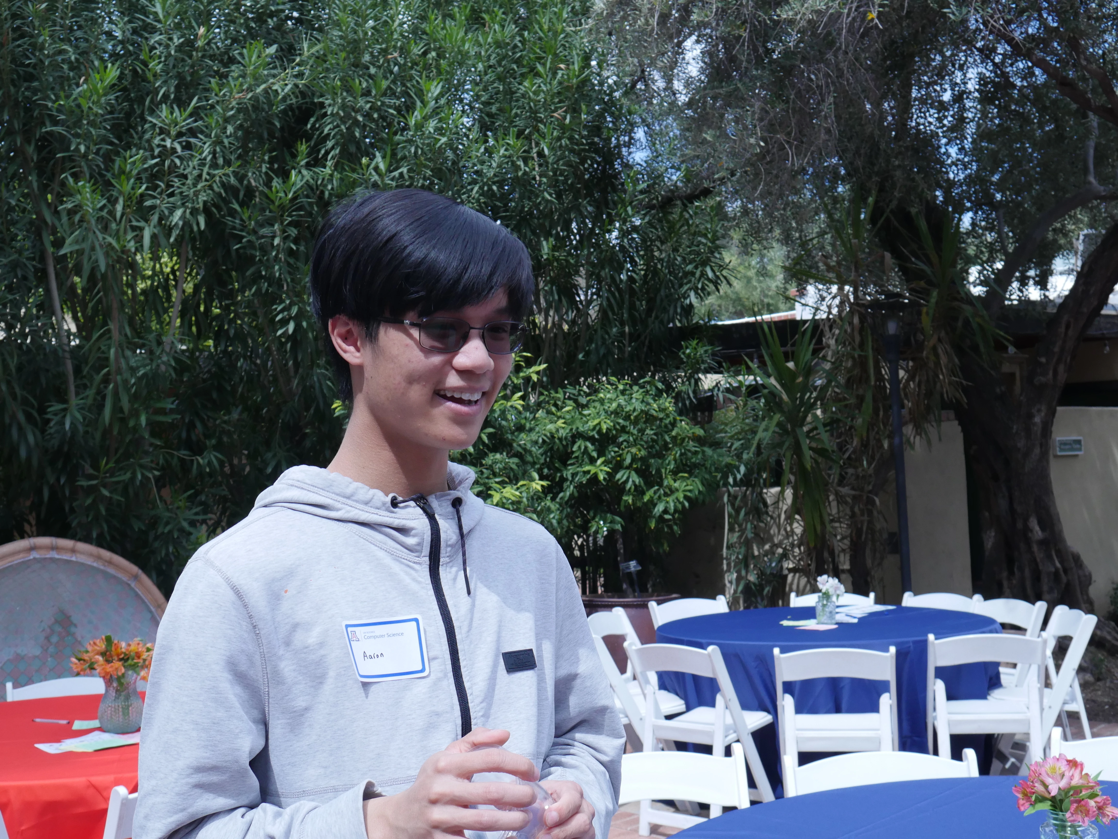 student laughing in conversation in TBG courtyard