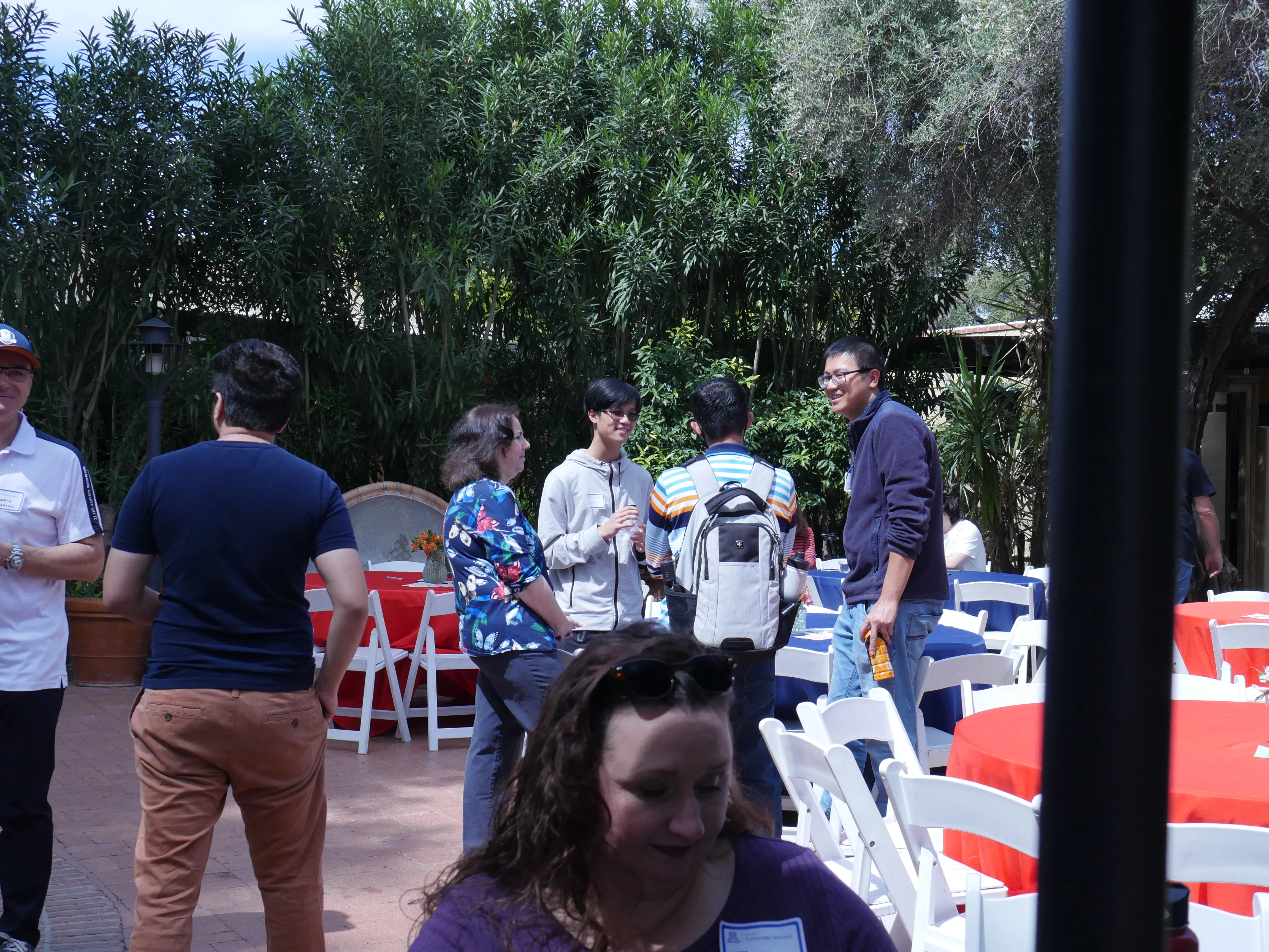 Faculty and students chatting in the TBG courtyard