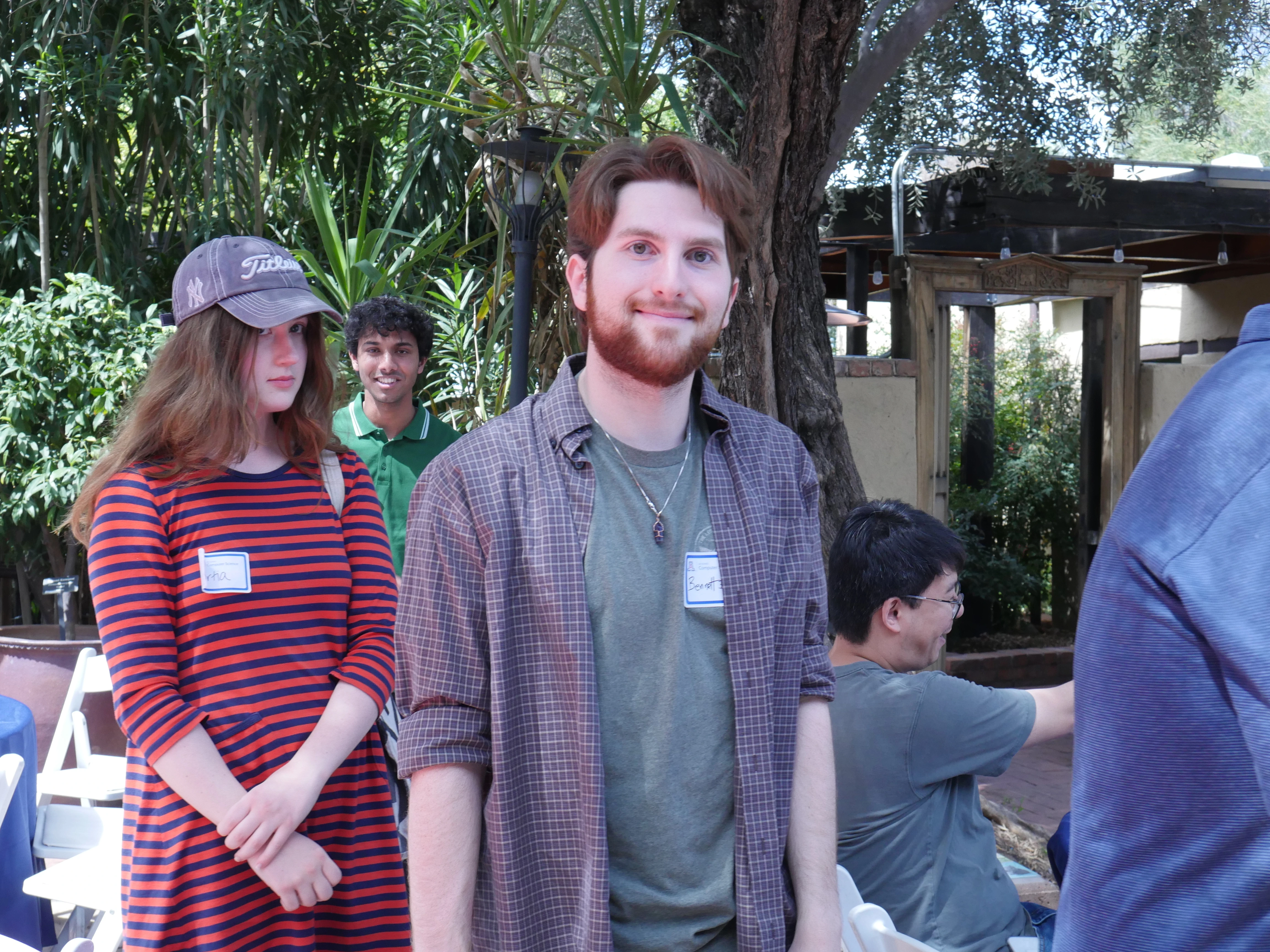 students waiting in a line at TBG courtyard