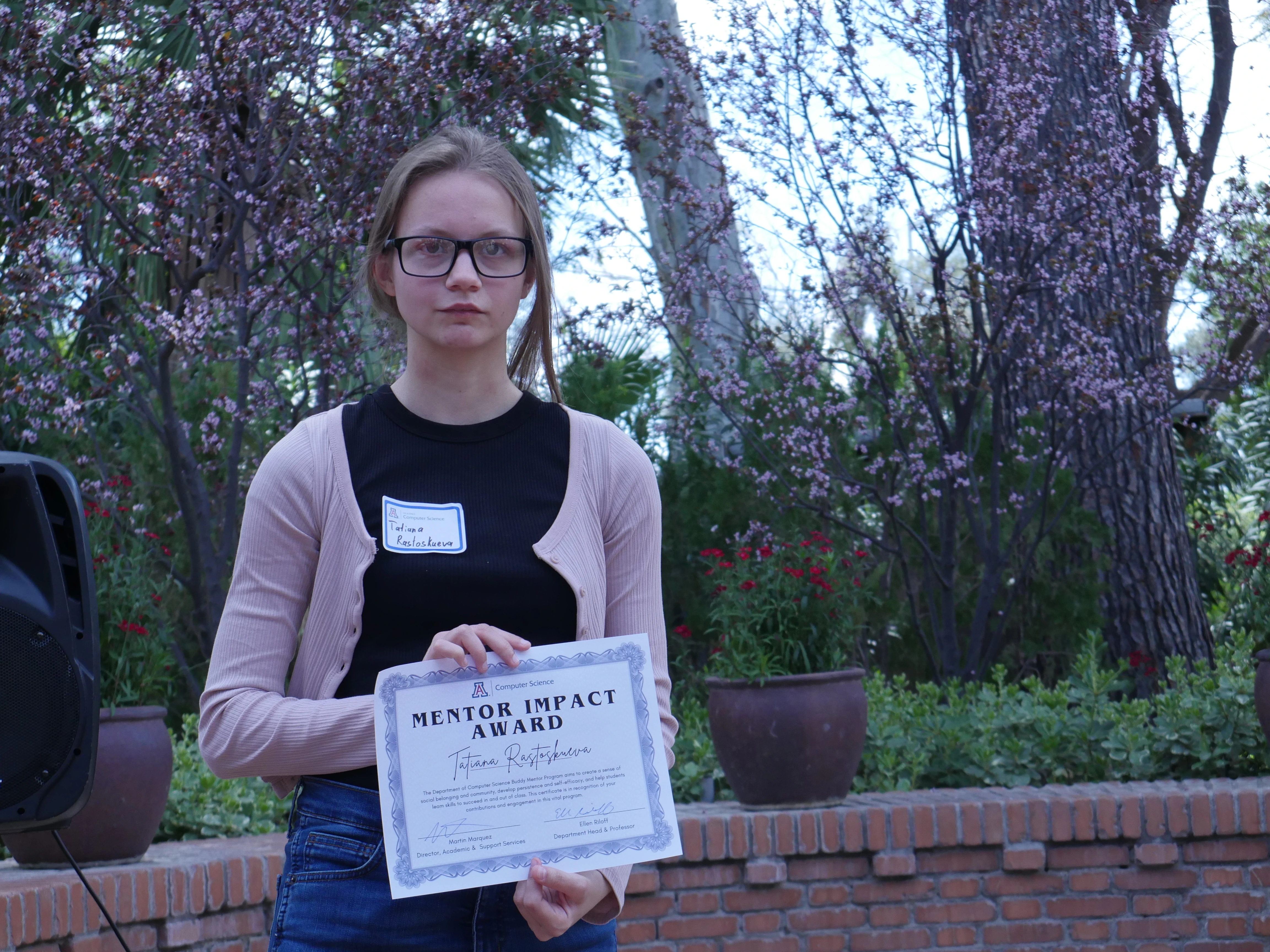 Tatiana displays her mentor Impact Award certificate