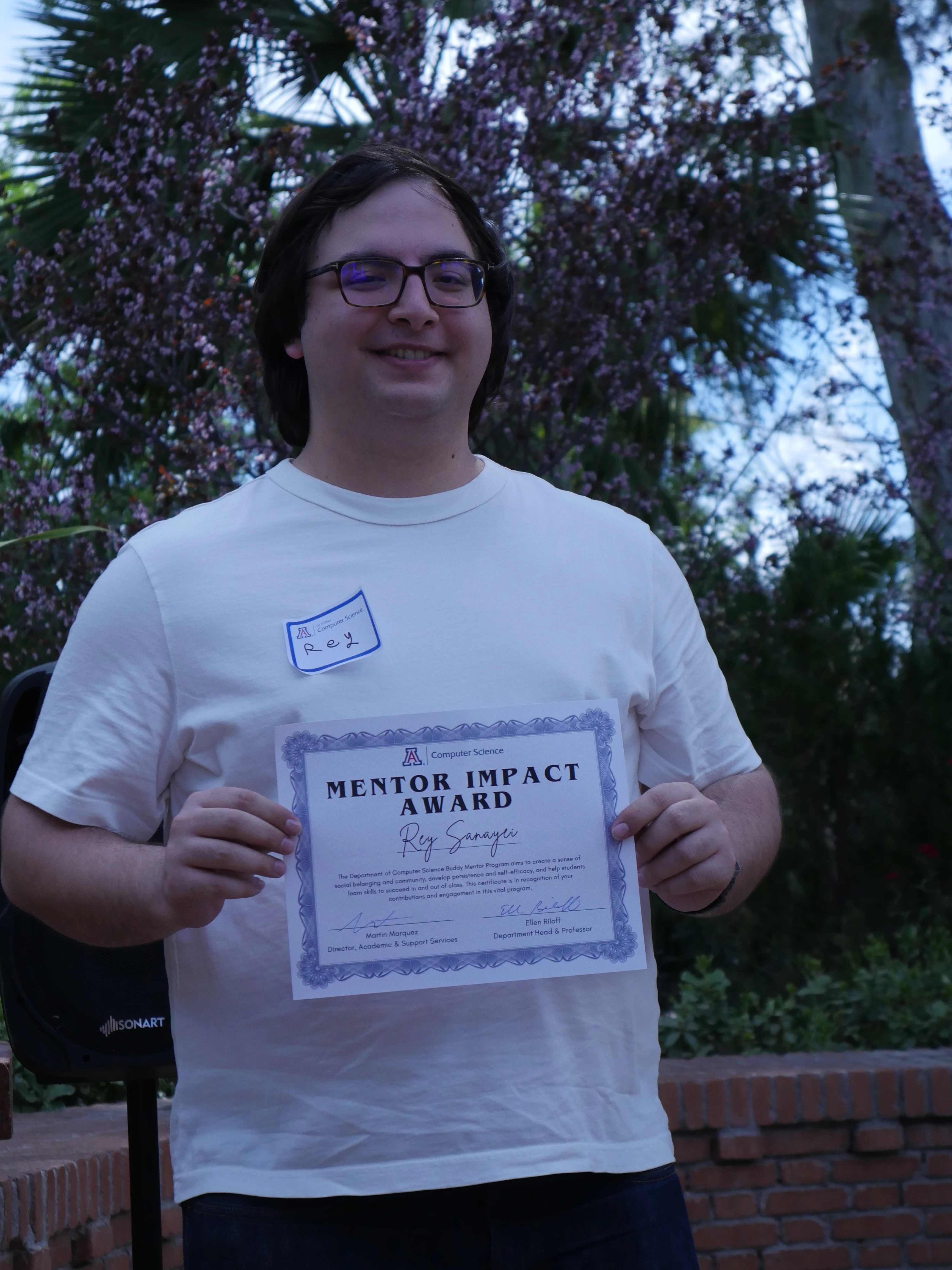 Rey displaying his certificate
