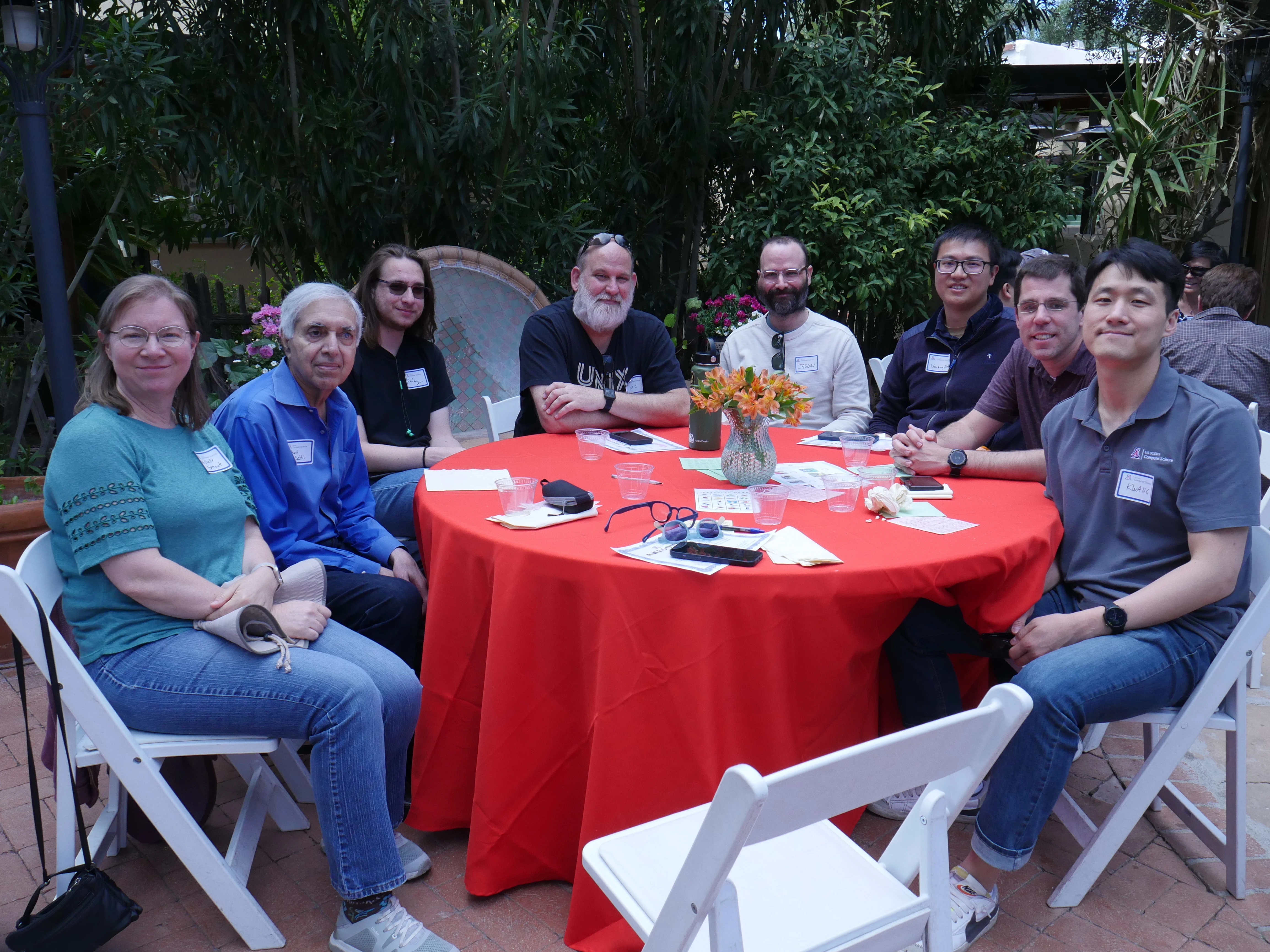 8 event attendees at a table with a red cloth (all faculty or staff)