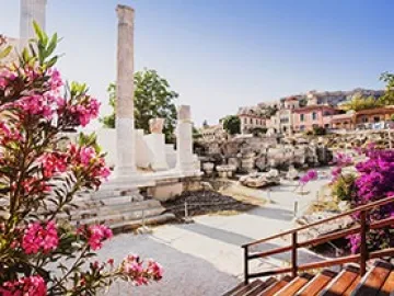 white walkway in athens with pink flowers and broken columns